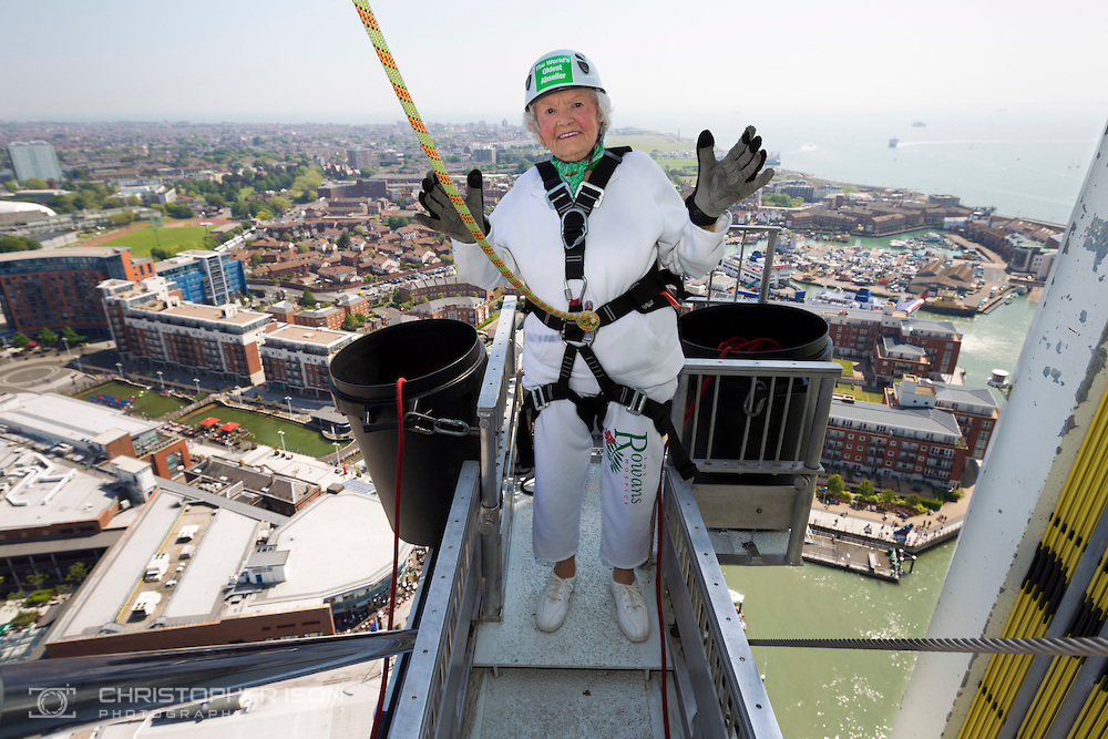 140518 ISON Doris Long Abseil Intrepid centenarian Doris Long MBE steps out onto the platform before abseiling down the 130 metre tall Spinnaker Tower in Portsmouth today, on her 100th Birthday. She performed the feat to raise funds for local charity, The Rowans Hospice and it is her 15th abseil. Daring Doris took up abseiling at 85 and today broke her own record of being the oldest person to abseil. Picture date Sunday 18th May, 2014. Picture by Christopher Ison. Contact +447544 044177 chris@christopherison.com
